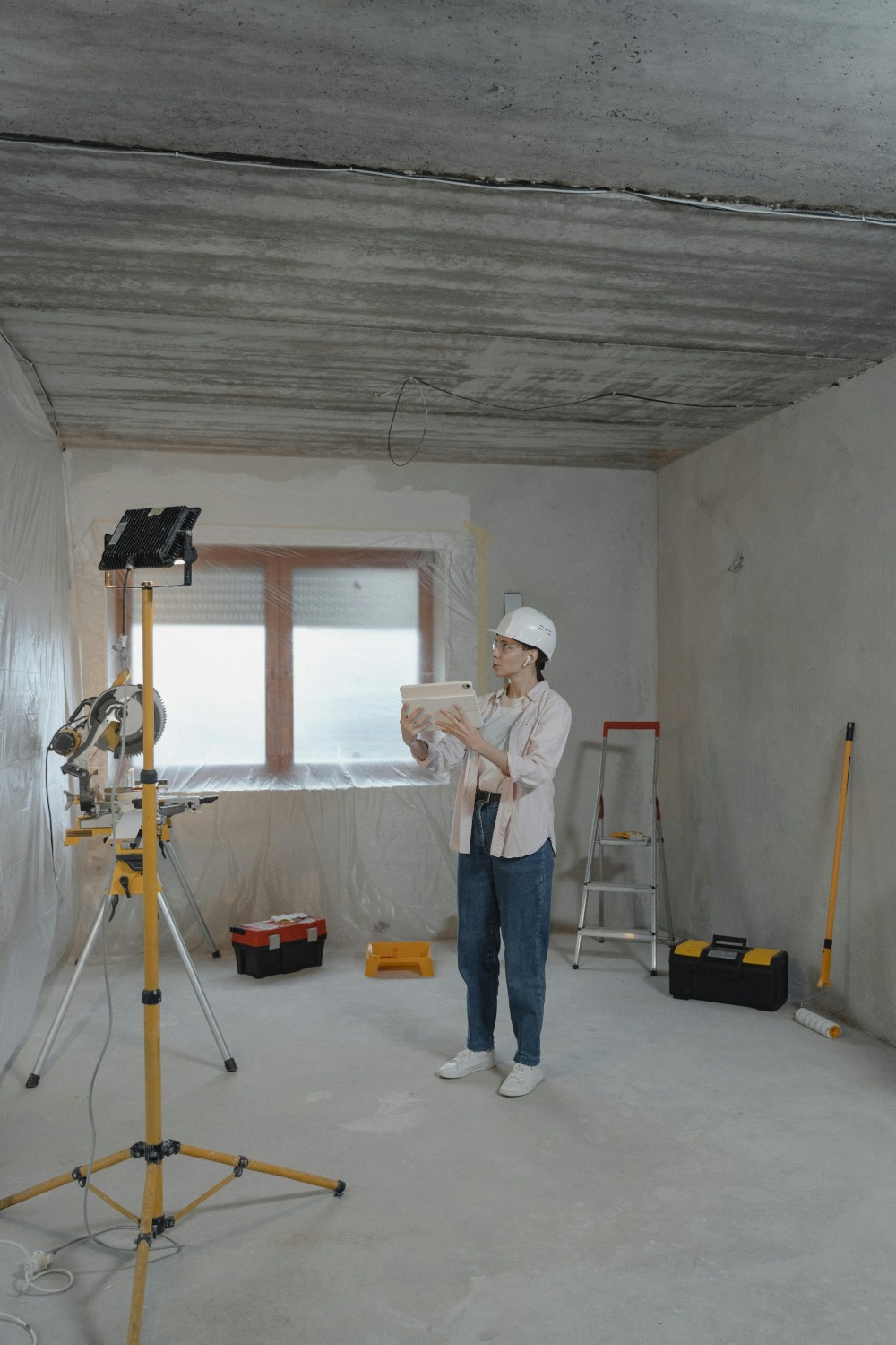 Inspector examining construction site with blueprints.