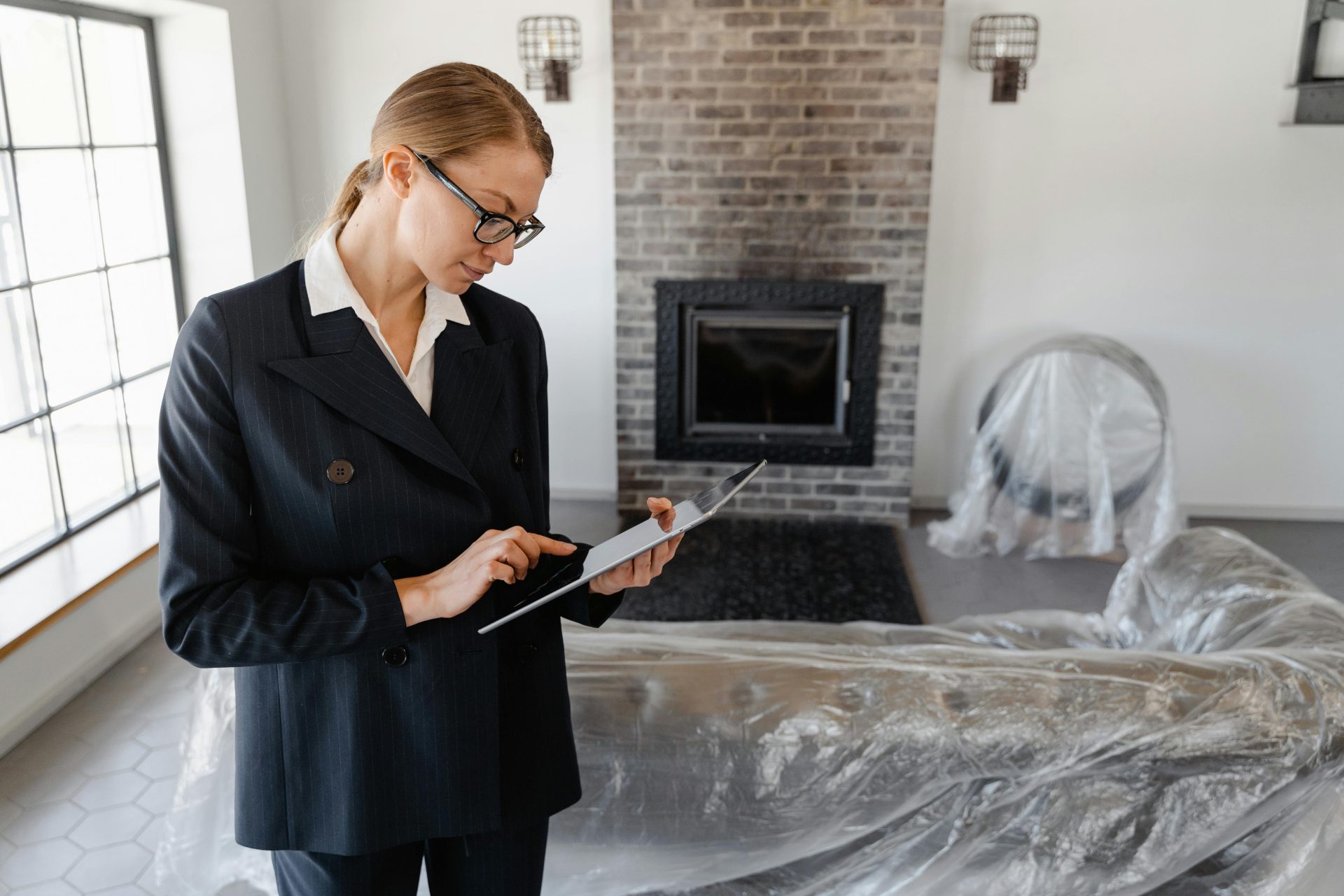 Home inspector examining interior with checklist tablet.