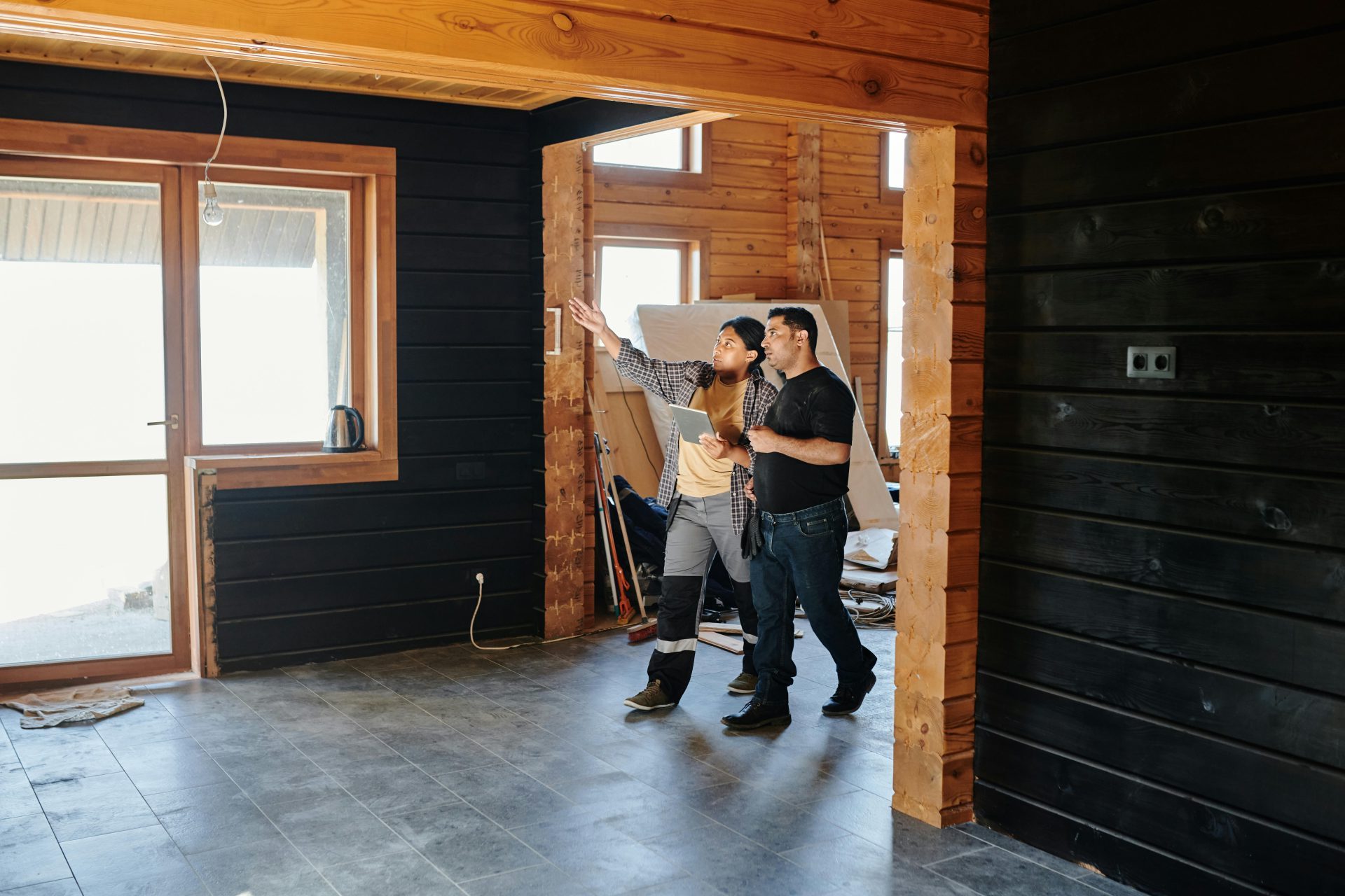 Couple viewing home renovation with contractor guidance.